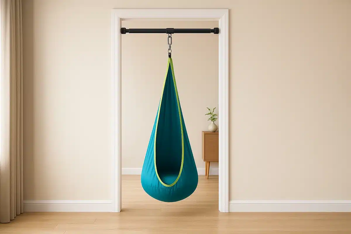 Doorway swing frame installed in a standard interior doorway with a pod swing attached
